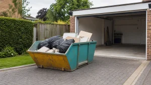A small skip on a driveway during a tidy garage clear out.
